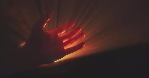 Reaching Hand With Sunlight and Golden Rays