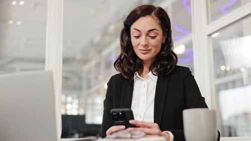 Businesswoman Using Mobile Phone in Modern Office