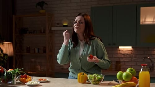 Woman Prepares Salad in Cozy Kitchen