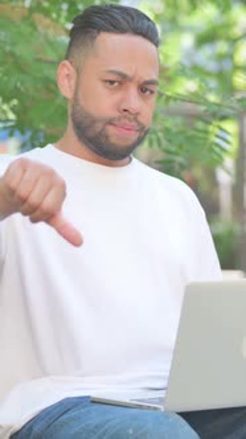 Vertical video, Thumbs Down by Middle Aged Man Using Laptop while Sitting Outdoor on Bench