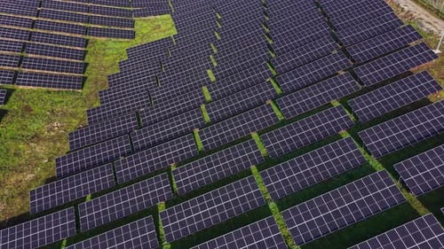 Solar panels cover a wide area of land in a renewable energy field