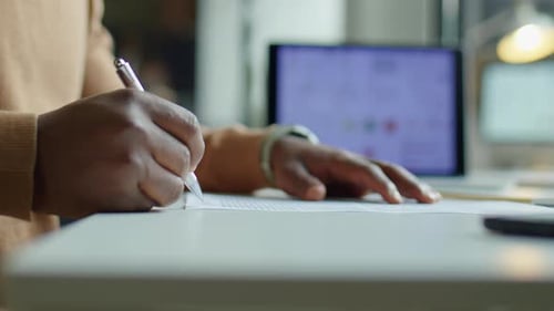 Close up on hands signing a business document