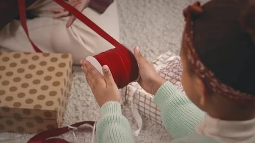 Child Gift Wrapping with Red Velvet Ribbon