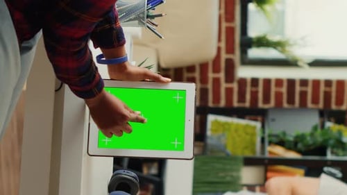 Woman Uses Tablet with Green Screen in Office