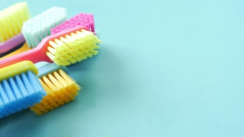 Colorful Toothbrushes on a Color Background Top View