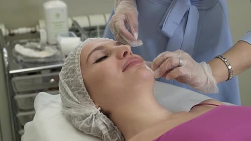 Woman Receiving Facial Treatment at Clinic