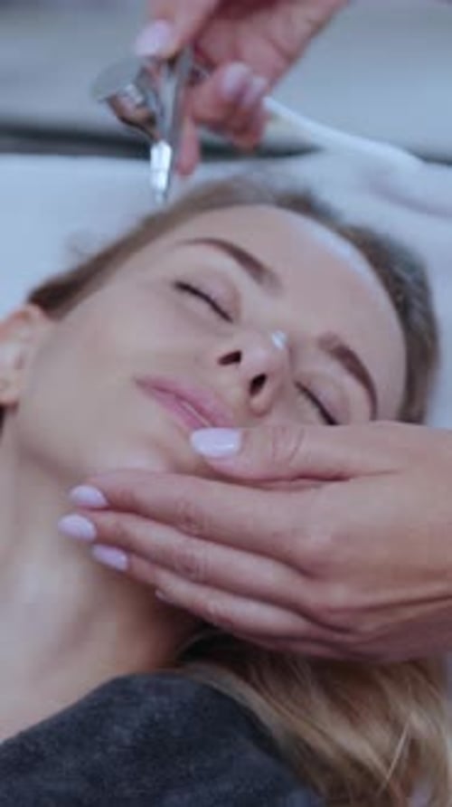 A Woman Enjoying a Relaxing Facial Treatment in a Calming Spa Setting for Beauty and Wellness