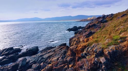 Rocks and boulders at the shore of the sea. Drone footage above the rocky coastline.