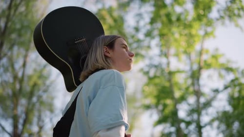 Energetic Singersongwriter in Park Bright Nature Scene with Performing Artist Casual Shot of