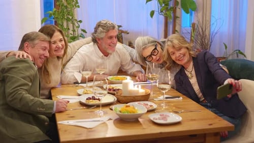 Group of Friends Take Selfie at Dinner Table