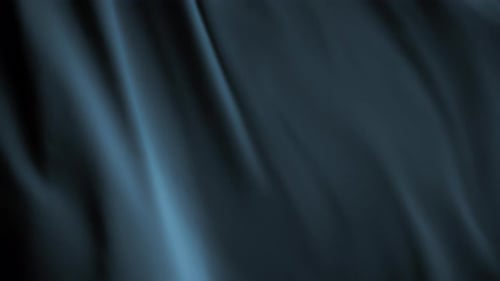 Dark grey chiffon textile waving in the wind. Abstract texture background.