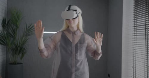 Woman Uses Virtual Reality Headset Indoors