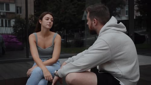 Woman and Man Talk in Urban Setting