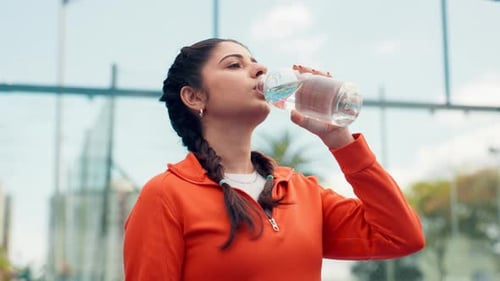Fitness, woman and drinking water on court with bottle for sports hydration