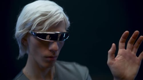Young Man with Futuristic Glasses Using Virtual Interface