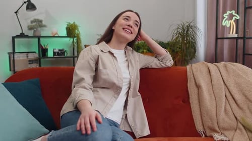 Smiling Woman Relaxing on Couch Indoors