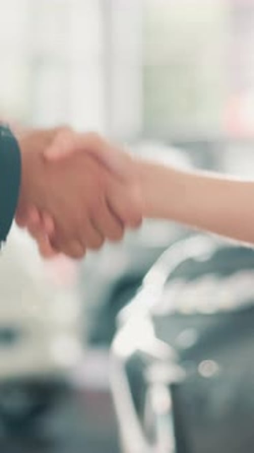 Keys, handshake and deal with people in car dealership for purchase success