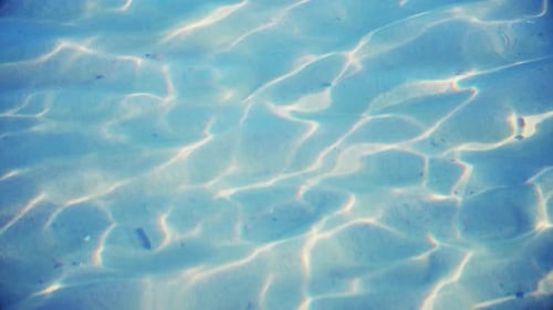 Sunlight Reflecting on Shallow Sandy Ocean Floor