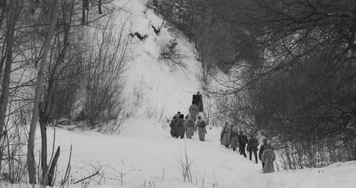Group Walking Through Snow-Covered Winter Landscape