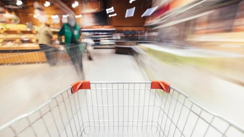 Time Lapse of Shopping Trolley Rushing Inside Supermarket Full of Food Products and People