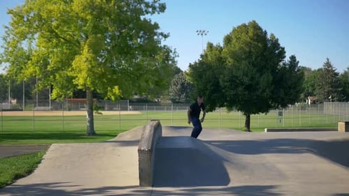 Skateboarder Performing Tricks at an Urban Skate Park