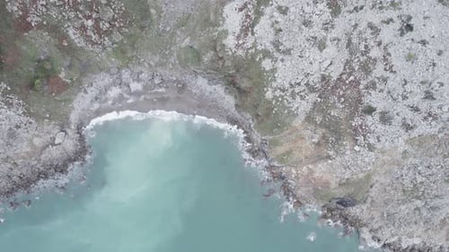 Foamy Turquoise Sea Washing Shore Surrounded By Rocky Cliff Cantabria Spain