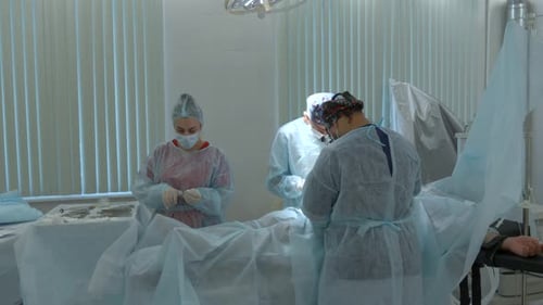Surgeons Performing Operation in Brightly Lit Operating Room