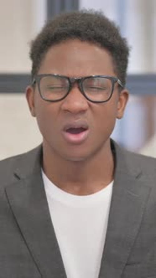 Vertical, Portrait of African American Man with Headache in Office