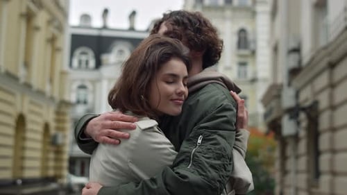 Happy Woman Leaning to Boyfriend on Urban Street. Lovely Couple Hugging On