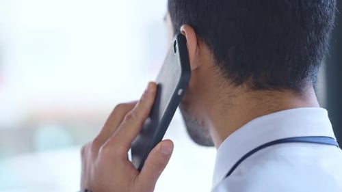 Business man talking on a phone call in an office