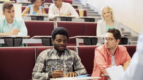 Group of International Students with Notebooks Sitting in Lecture Hall and Talking African