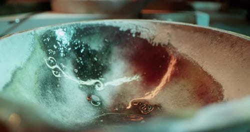 Jeweler Pouring Silver Powder Into Bowl