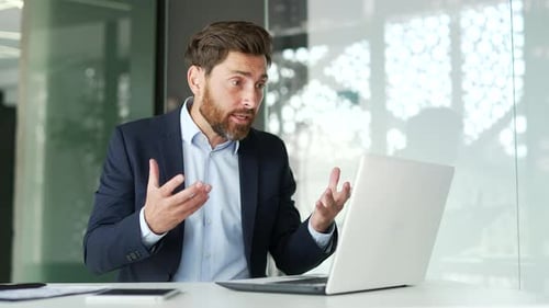 Enthusiastic Man Video Conferencing in Modern Office