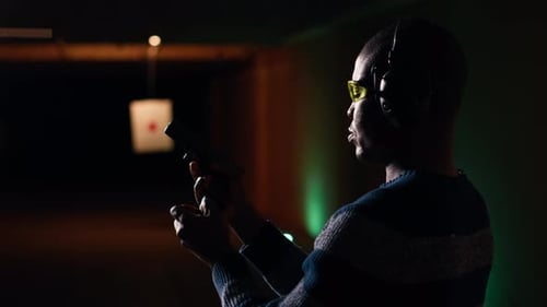 Portrait of Happy Shooting Range Customer Reloading Pistol Close Up