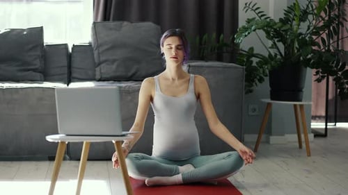 Pregnant Woman Practicing Yoga at Home