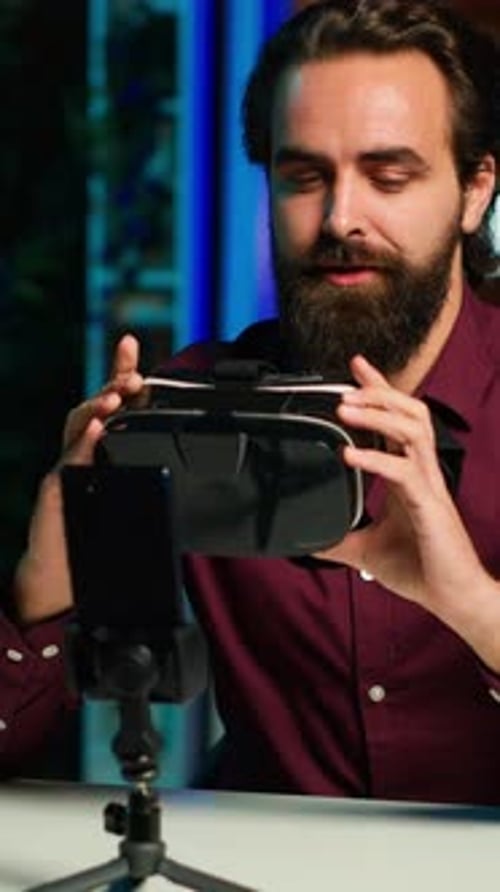 Man Demonstrates VR Headset to Phone Camera