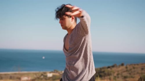 Man Doing Martial Arts by the Ocean