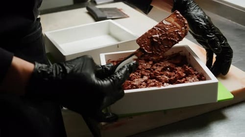 Chef Confectioner Making Chocolate with Nuts Dry Fruits Closeup Cooking Desserts Bakery and Candy