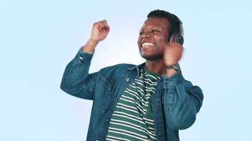 Man Wearing Headphones Dances and Celebrates