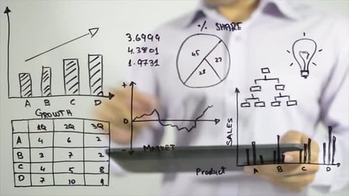Man Using Tablet with Business Graphs on Glass