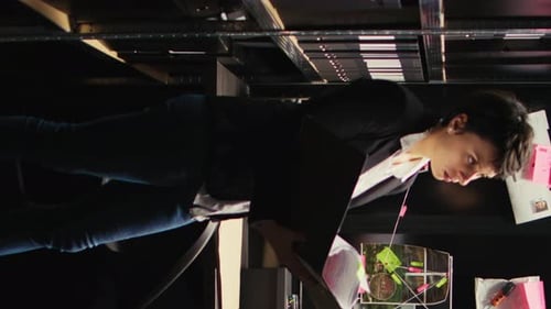 Young Adult Examining Evidence on Investigation Board