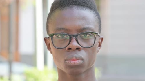 Close up of Serious Young African Man Face Outdoor