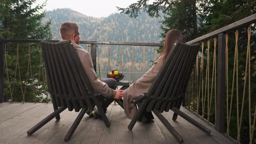 Romantic Couple Holding Hands on Cabin Porch