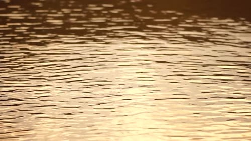 Ripples on Water Surface with the Reflection of Sky and Clouds Clouds in Blue Sky Reflect on Lake