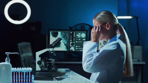 Scientist Working with Microscope in Modern Lab