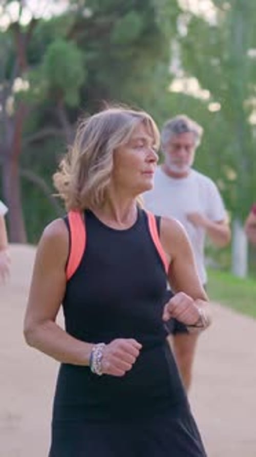 Active Senior People Jogging Together in a Park