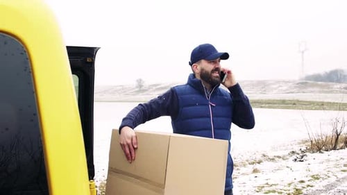 Delivery Man with Smartphone Delivering Parcel Box to Recipient