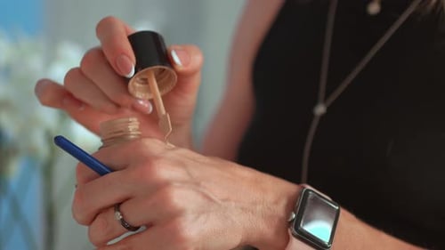 Makeup Artist Preparing Foundation for Client in Studio