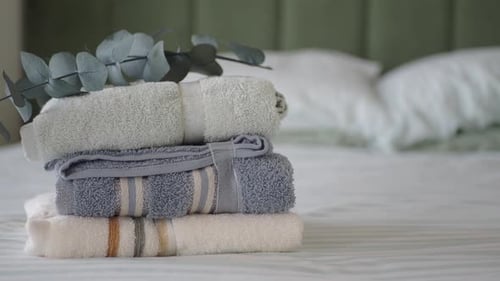 Freshly folded towels in bedroom interior, hotel