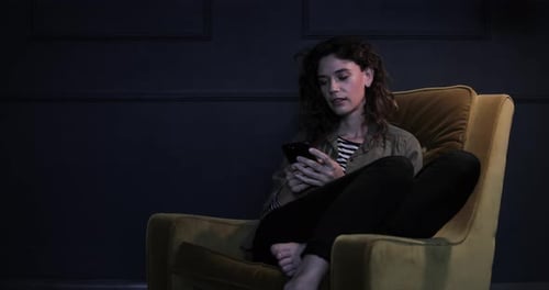 Adult woman working late at night in dark home office